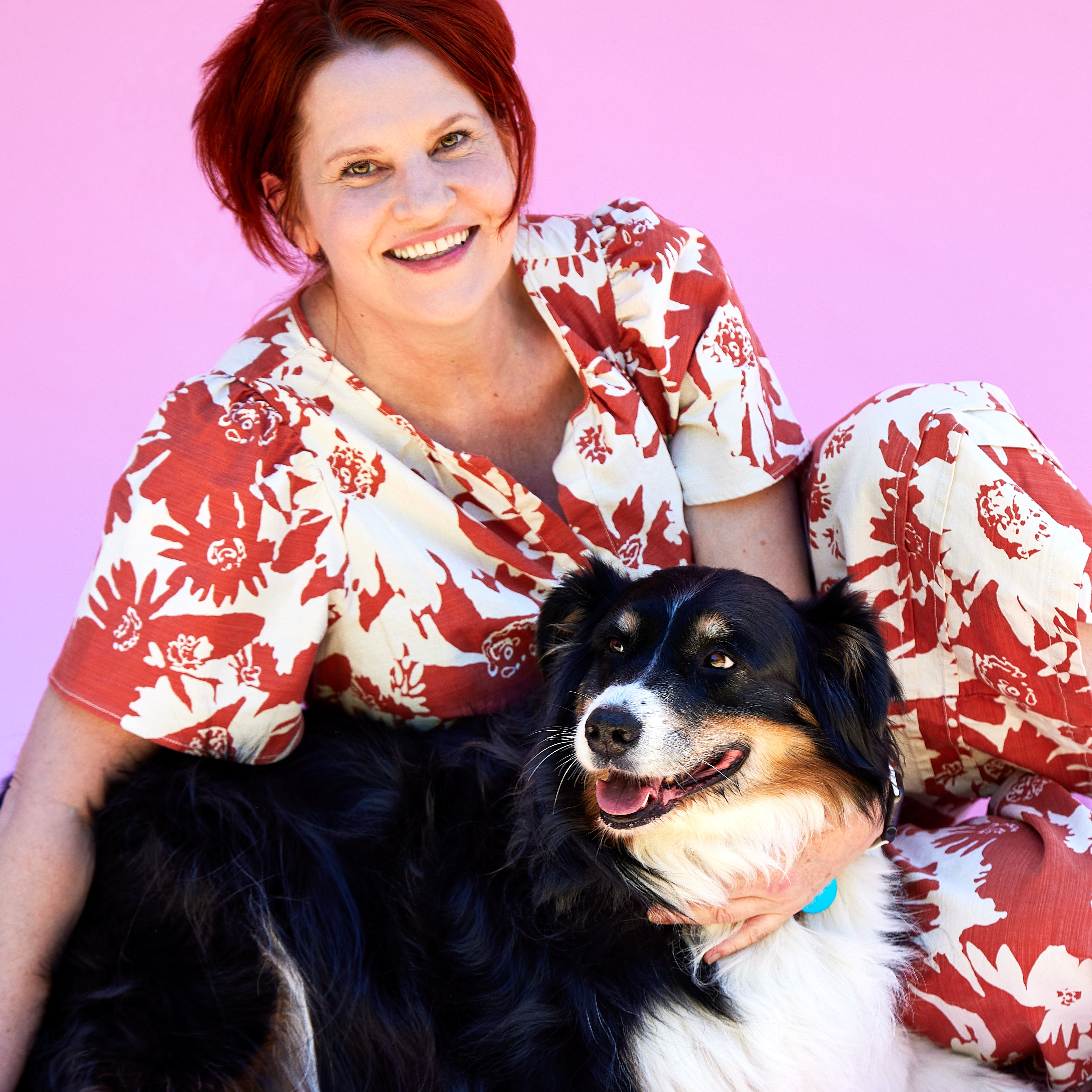 Couple feeding puppop to their small dog